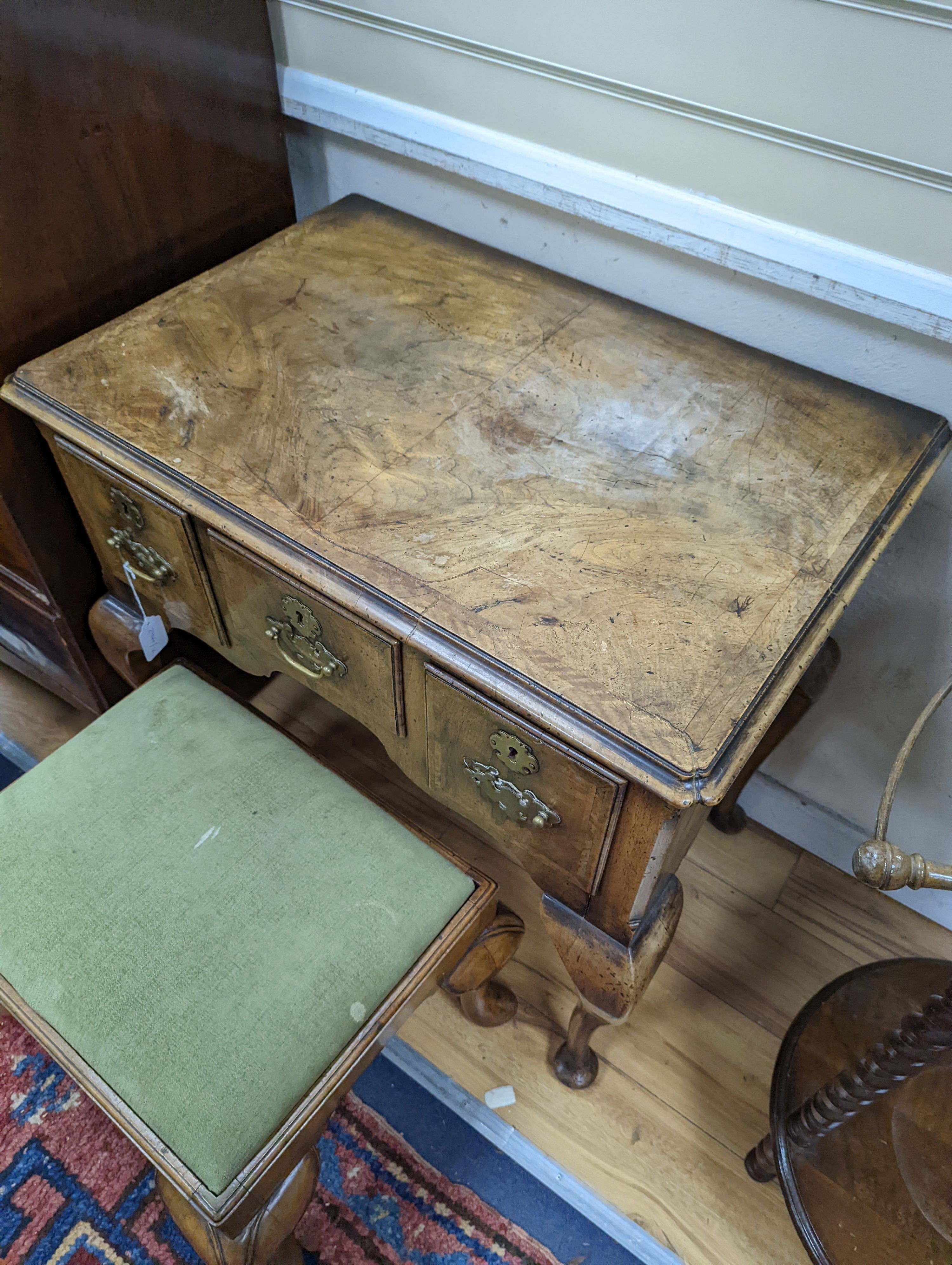 A 1920's Queen Anne revival banded walnut lowboy, width 76cm, depth 51cm, height 75cm together with a similar rectangular walnut dressing stool